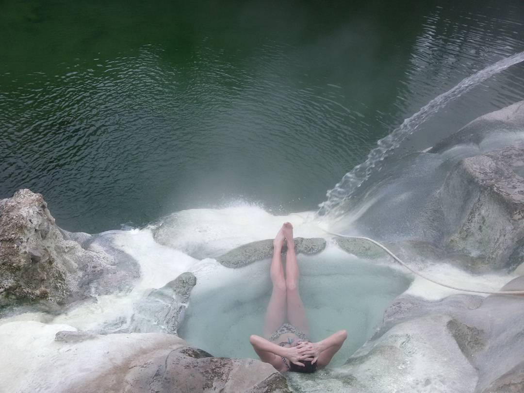 a woman bathing in the wild hot springs in tuscany