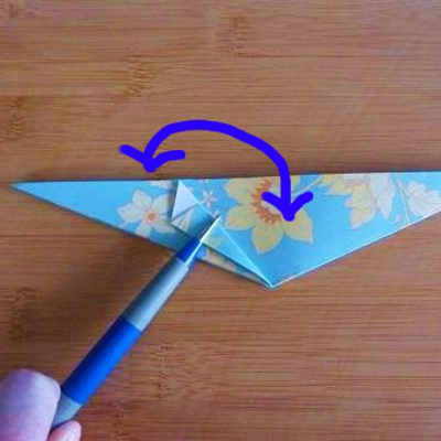 Folding the origami design in half