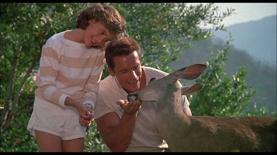 Arnold Schwarzenegger and Alyssa Milano handfeed a cute young deer (Commando, 1985)