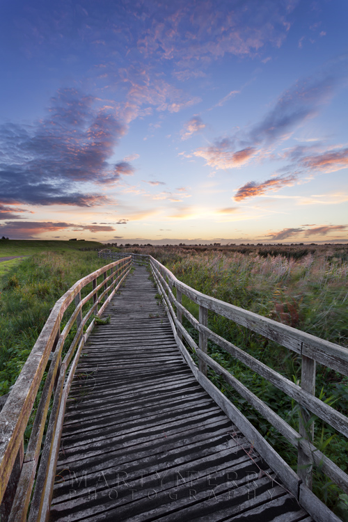 Sunset at Ouse Washes from a wooden walkway Colours at sunset over the Cambridgeshire Fens at Ouse Washes