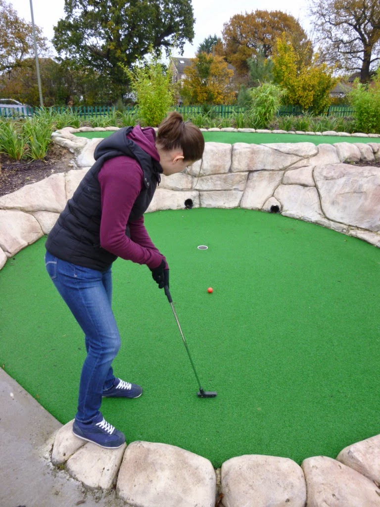 Emily Gottfried holing-out a long second putt at the Jungle Island Adventure Golf course at Horton Park Golf Club in Epsom