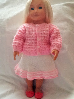 http://www.craftsy.com/pattern/knitting/toy/beaded-cardigan-and-skirt-18-inch-doll-/169938