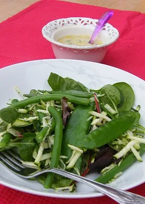 green bean salad in a white bowl with creamy salad dressing