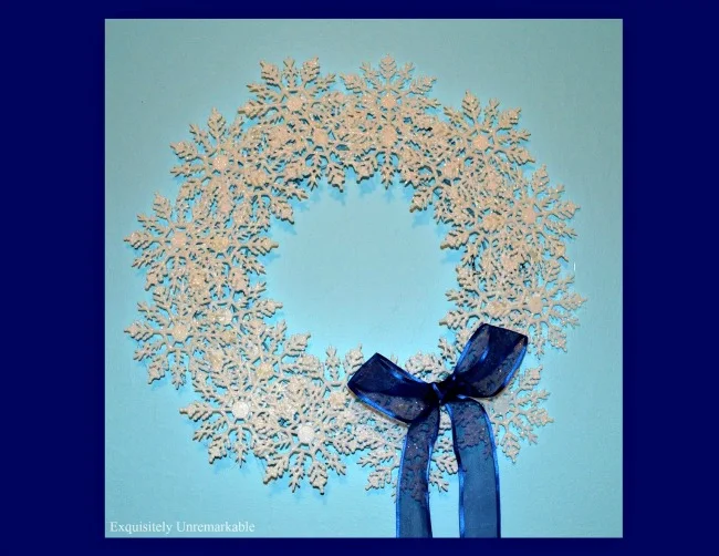 White snowflake wreath on blue wall