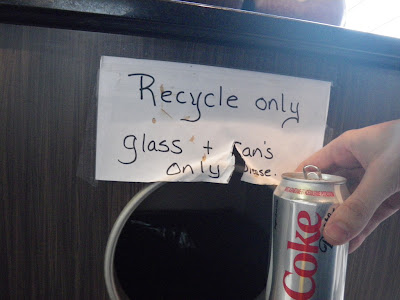 paper sign with text reading Recycle Only glass + can's please.