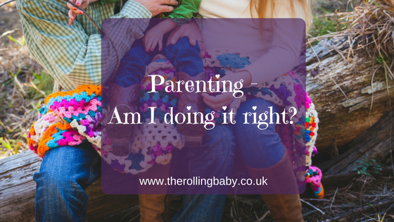Parenting - Am I doing it right? Mother, father and child sitting on a tree trunk with a multi coloured blanket over them