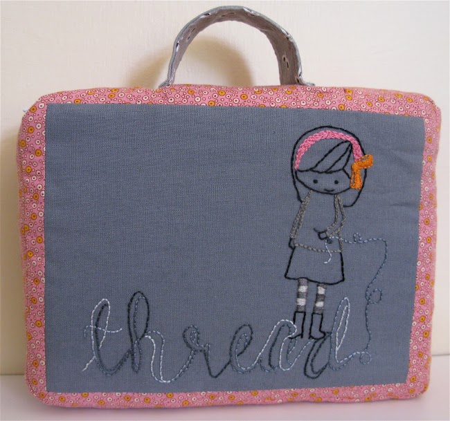 the word thread embroidered in loopy style with cartoon girl holding sewing needle