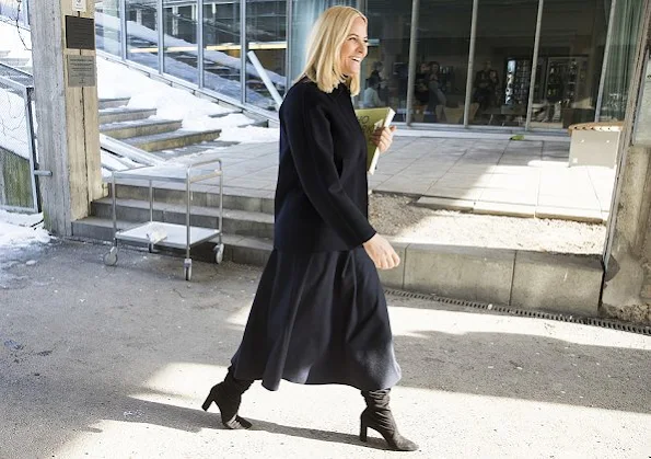 Crown Princess Mette-Marit of Norway visited the Oslo School of Architecture and Design. Princess Prada boots and Stella McCartney wool coat