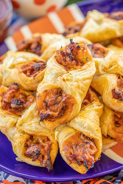Pulled Pork Pastry Puffs - only 4 ingredients! Great recipe for a quick lunch, dinner or party. Smoky pulled pork tossed with BBQ sauce and cheese then baked in puff pastry. SO good! Can make ahead and freeze for later. We love to serve these with some coleslaw and extra BBQ sauce or Ranch for dipping. YUM! #pulledpork #partyfood #appetizer #tailgating Pulled Pork Pastry Puffs - only 4 ingredients! Great recipe for a quick lunch, dinner or party. Smoky pulled pork tossed with BBQ sauce and cheese then baked in puff pastry. SO good! Can make ahead and freeze for later. We love to serve these with some coleslaw and extra BBQ sauce or Ranch for dipping. YUM! #pulledpork #partyfood #appetizer #tailgating