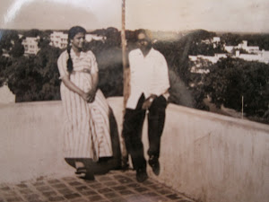Parents on terrace of "Mehrle Devji Building" in Mombasa.