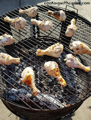 drumsticks being grilled over wood fire