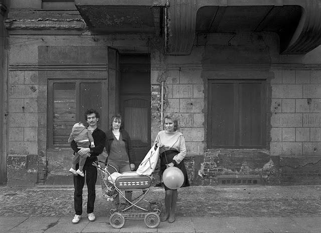 Frau Baer (center) with her daughter, her grandchild, and her daughterâs partner on the thirty-eighth anniversary of the founding of the GDR.