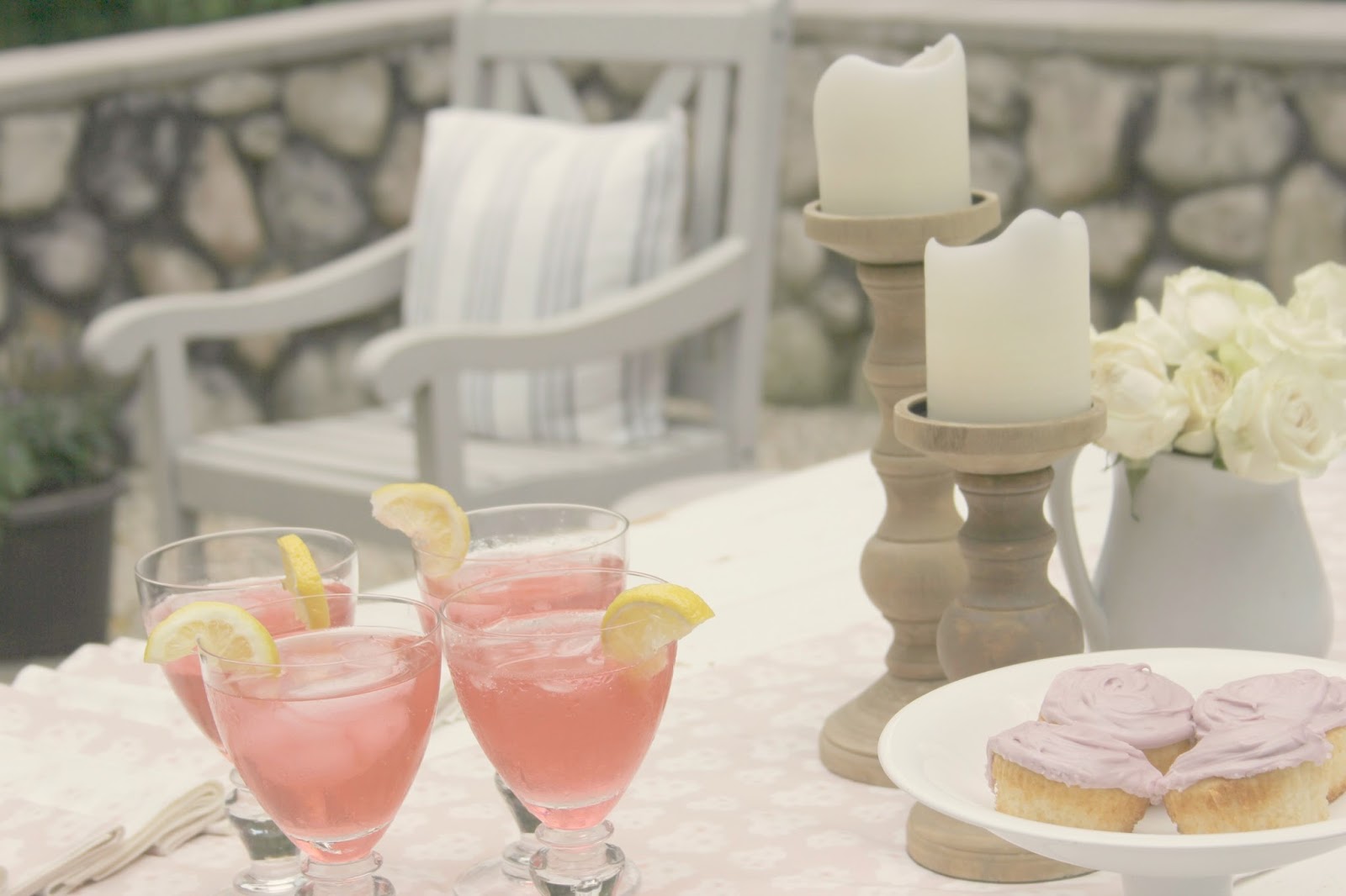 White farm table set with cupcakes and cocktails - Hello Lovely Studio