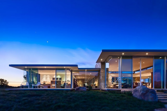 Architecture of the Home with Glass Walls and Flat Roof near Grass Yard