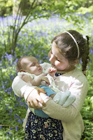 Big Sister A girl holding her baby brother.