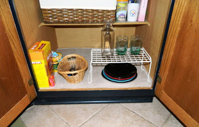 Low cabinet in a kitchen that is set up for kids, including some snacks