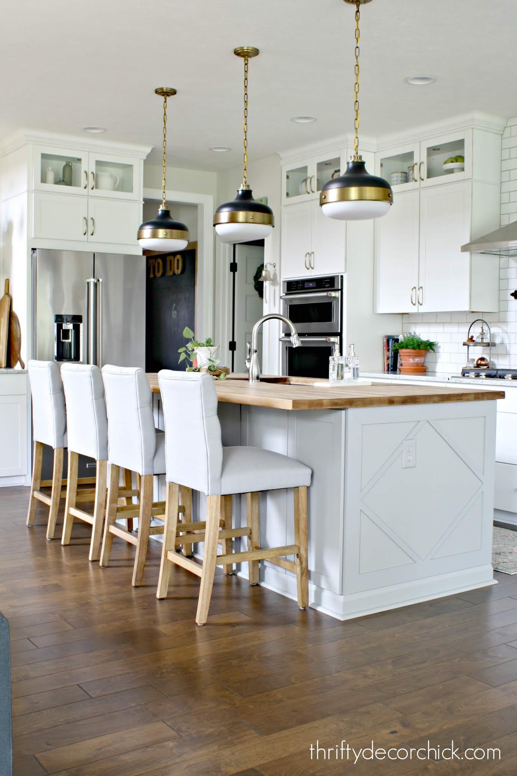 Light gray island white cabinets kitchen 