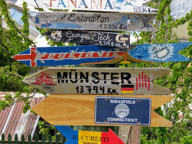Signs pointing to cities around the world at Cerro de la Cruz in Punta Arenas Chile