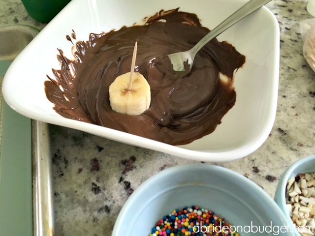 A tasty homemade wedding favor idea is always a good choice. And these Chocolate Dipped Banana Bites Wedding Favors are perfect. Get the recipe at www.abrideonabudget.com.