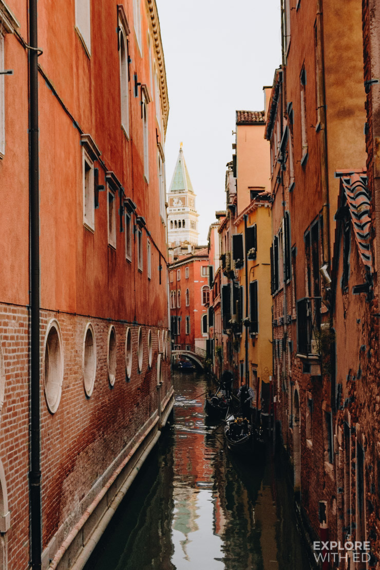 Canal tours in Venice passing near St Mark's Square with a view of the Bell Tower