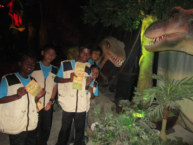 Children from Rumah Kebajikan Mary at the baby T-Rex exhibit