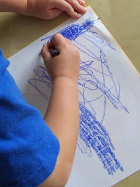 Easy Sight Words Activity by coloring over stickers to spell out words with blue crayons on white paper.