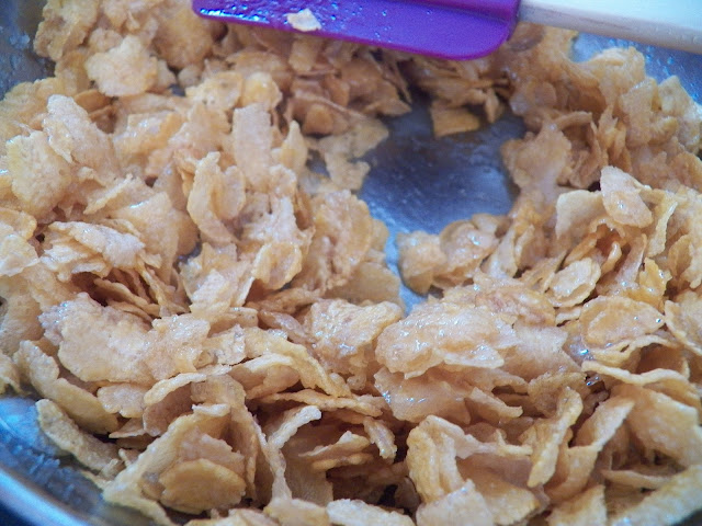 Cornflakes added to pan of butter and sugar and coated