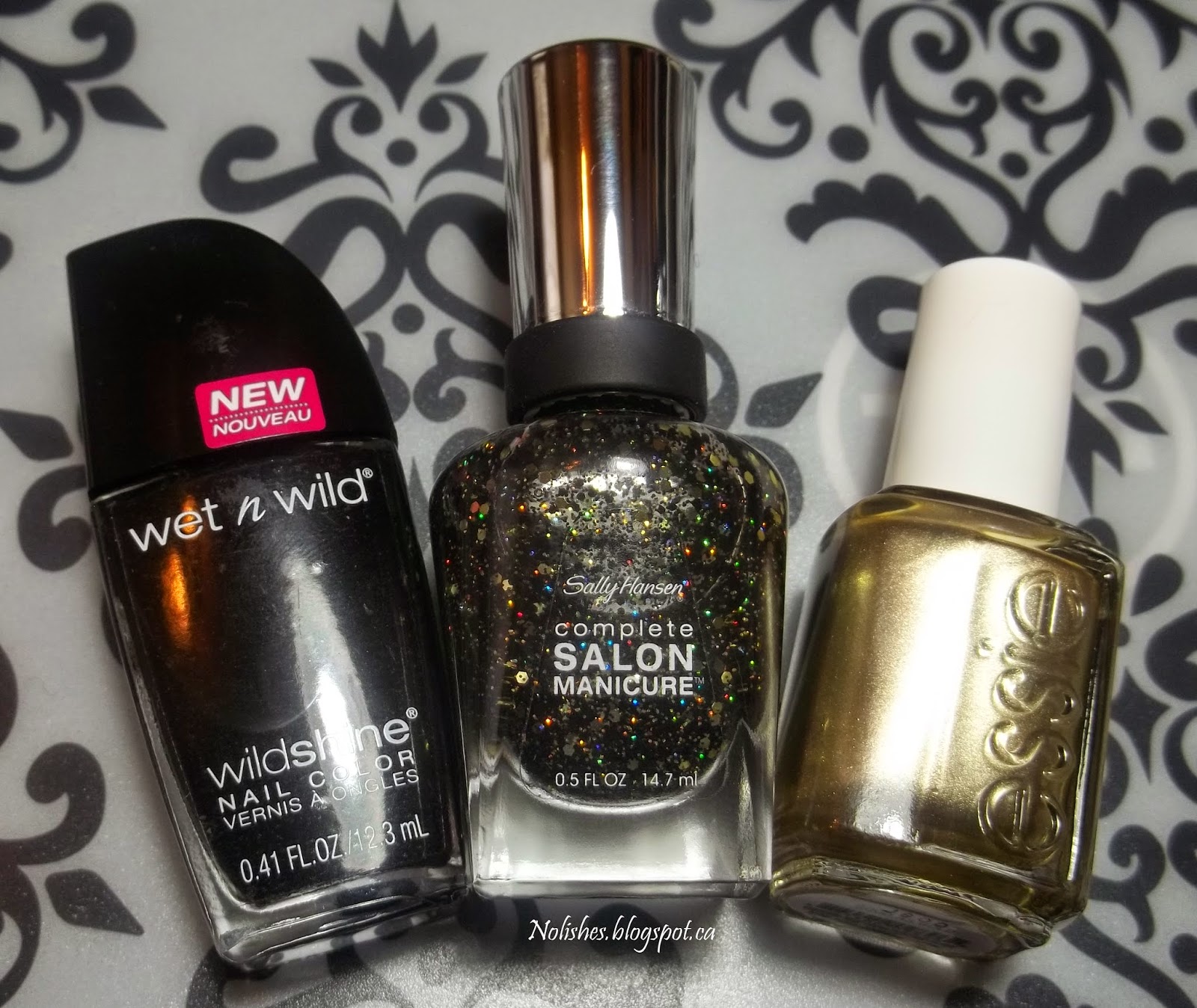 Wet n Wild Wild Shine ‘Black Crème’, Sally Hansen Complete Salon Manicure ‘Midnight Glitz’, and Essie ‘Good as Gold’