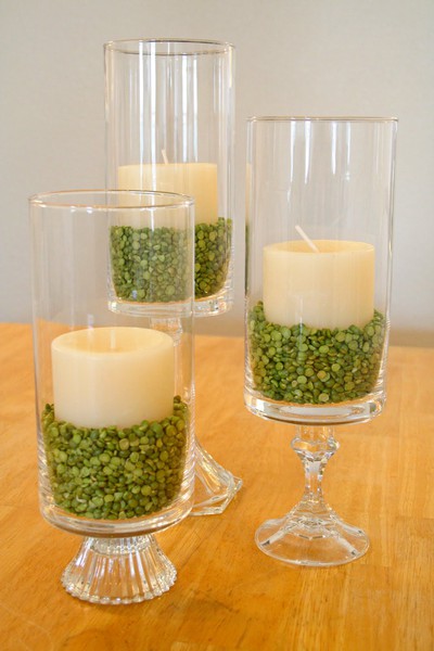 Candles in vases resting on split peas are elegant table accents. 