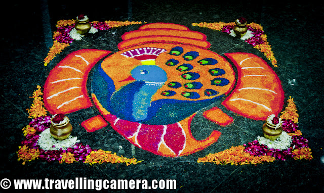 Diwali Rangoli,Art at Adobe, Rangoli is a traditional decorative folk art of India. These are decorative designs made on floors of living rooms and courtyards during Hindu festivals and are meant as sacred welcoming areas for the Hindu deities. The ancient symbols have been passed on through the ages, from each generation to the one that followed, thus keeping both the art form and the tradition alive. Rangoli and similar practices are followed in different Indian states; in Tamil Nadu, one has Kolam, Madanae in Rajasthan, Chowkpurna in Northern India, Alpana in Bengal, Aripana in Bihar, and so on. The purpose of Rangoli is decoration and it is thought to bring good luck. Teams make rangolis every year before Diwali at Adobe. However, this time the patterns were incredibly intricate and imaginative.Om is the sacred symbol of Hinduism, Buddhism, and Jainism and can often be seen in religious arts. Rangoli is no exception.The traditional rending of a new bride in a Doli. In medieval and ancient India and for a long time even in modern India, after marriage, dolis bourne on the shoulders of 4-6 men were used to transport the new bride to her husband's home. Marigold flowers (गेन्दा) are inseparable from Hindu Prayers and religios decorations. Idols of Deities are often adorned with garlands of marigold flowers and red roses.This is a clever integration of a peacock in the face of Lord Ganesh. While the peacock is the greatly revered in Hindu Scriptures, Lord Ganesh is the deity who the Hindus rely upon to take care of new entreprises. Beautiful colors and image! The peacock is also the National Bird of India.A pattern with the peacock in the center and outlined with marigold and rose petals.A Peacock is often referred to as a bird with a hundred eyes owing to the eye-like patterns in its tail feathers. The Kalash (a brass pot) is a symbol of abundance in Hinduism. It is often worshipped during the yagyas along with the deities in Arya Samaj branch of Hinduism. Full rendering of a peacock on the branch of a flowering plant with symbols of various Adobe Products in its tail. It is holding a scroll with the symbol of Adobe and the Sacred Swastik in its beak. Swastik, contrary to common knowledge, is an ancient holy symbol in Hinduism. Unfortunately, it was used by Nazis and after that the real, holy meaning seems to have been lost to the world. But in India, it is still used with a lot of respect in almost all religious ceremonies.  Lord Ganesh with his elephant head and human body. Lord Ganesh is widely worshipped along with Goddess Lakshmi (the Godess of Wealth) during diwali. Lord Ganesh, himself, is considered to be the God of New Beginnings, someone who removes hurdles. Another colorful design with the logos of various Adobe products, You can see the well know photoshop, Premiere Pro, Dreamweaver, Acrobat, InDesign etc.Diya's (earthen lamps) are used during diwali to decorate houses and businesses. They are shallow vessels made of clay or brass and have a cotton wick dipped in mustar oil.This design is more traditional with Om and a stark white color against a bright red. Two peacocks with their royal blue necks and bright green plumage. Peacocks seemed to rule the designs this year. A new age Ganesh with his vehicle, a mouse. If you look closely, the mouse if offering him an Apple that looks strikingly similar to the logo of the Software Giant of the same name. While the word Adobe has been written in a calligraphic script at the top. Cheeky!A close-up of the Kalash. This one is earthern but has been paited over with a metallic paint. Around it are typical colors of Hinduism, saffron and yellow. A close-up of the calligraphic Adobe.  Baby Ganesh, floating on a cloud, over a colorful carpet of Adobe Products. Whether this cloud is a spiritual cloud or the technical cloud, is open to interpretations. Another colorful and elaborate design with Ganesh and Swastik, The shape of a mango is another common shape in Indian arts. You'll find it used in abundance in mehndis (henna tattoos) and rangolis.Photoshop, flash, Dreamweaver, Bridge and other Adobe products around an Adobe symbol. A fancy earthen Diya full of blue rangoli color.Lord Ganesh, in his various forms, has inspired many artists. And as a result, his form has been used extensively in all kinds of arts, starting from Rangoli to paintings to sculpting. Simple, yet pretty.Adobe employees admiring one of the rangolis. Elephant, another symbol of Hinduism. This one's a tusker and is carrying Adobe on its back. Elephants are closely related to Lord Ganesh. The Rangolis are as colorful as Adobe itself. This particular Rangoli is of a dancing Lord Ganesh.Happy Diwali,  Rangoli, Art,  hinduism, Ganesh, Om, Religion, Art, Colorful