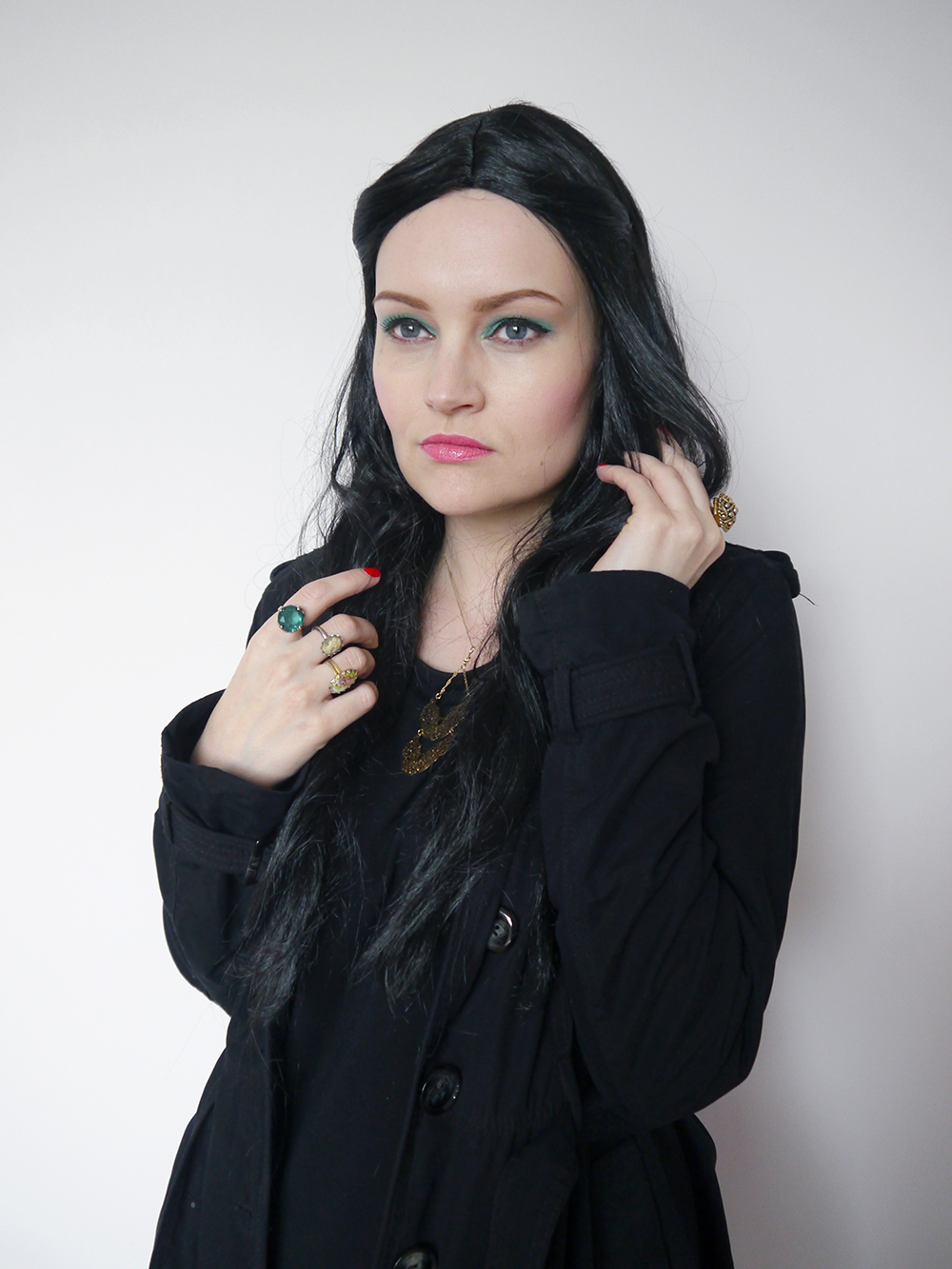 Blogger Kimberley from Wardrobe Conversations dressed in witch Halloween costume with only a black dress, a wig and some jewellery