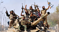 Libyan government fighters celebrated after routing the last remaining forces loyal to Col. Muammar el-Qaddafi.