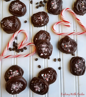 These peppermint mocha shortbread cookies are just like the coffee house drink but in chewable form. Put some on your Christmas cookie trays to take them to the next level! chocolate and peppermint topped mocha shortbread cookies, coffee beans and candy cane hearts