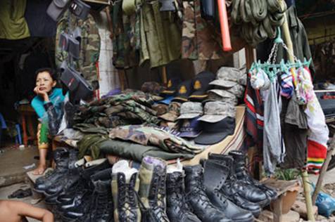 vendor sells military apparel at a clothing stall at Teuk Thla ...
