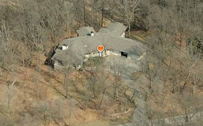 Aerial photo of very large suburban house surrounded by woods