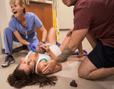 woman delivers baby emergency room hallway