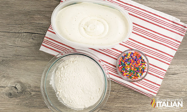 soft ice cream and flour in bowls on striped kitchen towel to make an ice cream bread recipe