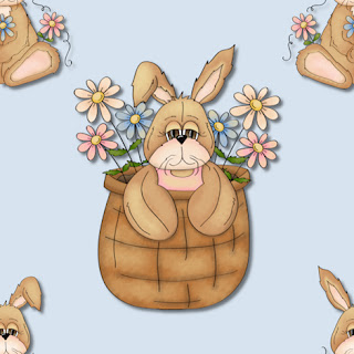 Clipart image of a bunny in an Easter basket with spring flowers