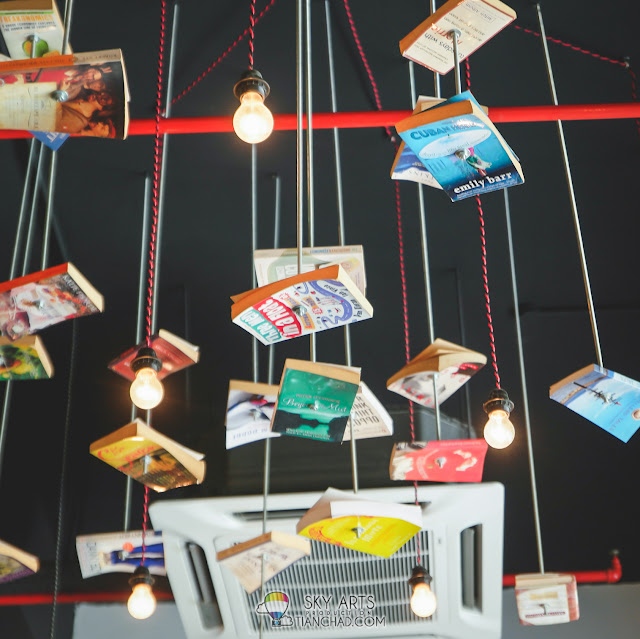 Books hanging in the middle of the air with simple lighting around it