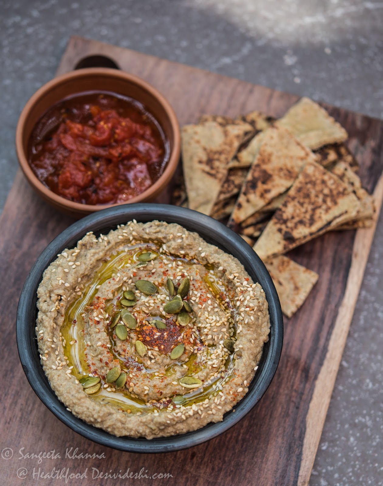 green mung bean hummus with green pitted olives and mixed seeds tahini