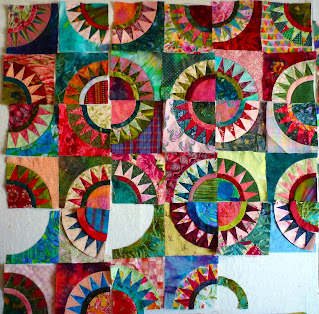 Red, pink, green and blue quilt blocks with quarter circles and five teeth.
