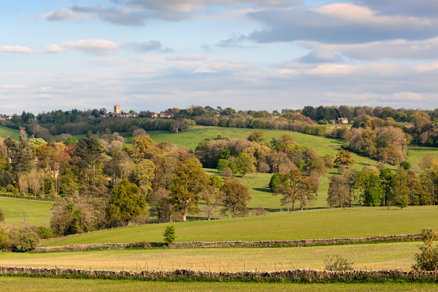 Stow church on a hill and surrounding Cotswold landscape in the late afternoon light