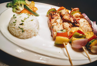 Hawaiian chicken kebabs kabobs with parsley butter rice and sauteed vegetables