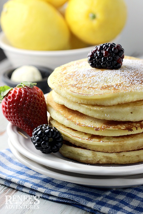 Lemon Ricotta Pancakes stack on plate with fruit