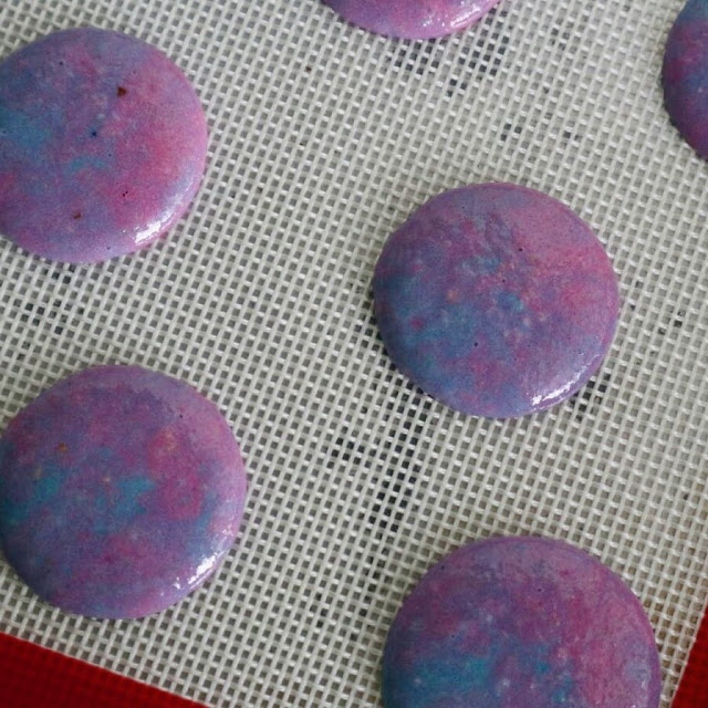 colourful aloha macarons after they have been piped