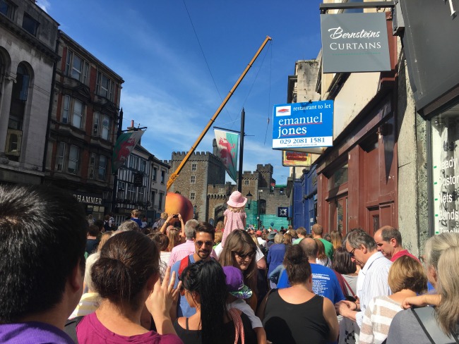 City-Of-The-Unexpected-Cardiff-Celebrates-Roald-Dahl-crowds-crushed-together-giant-peach-just-appearing-in-front-of-castle
