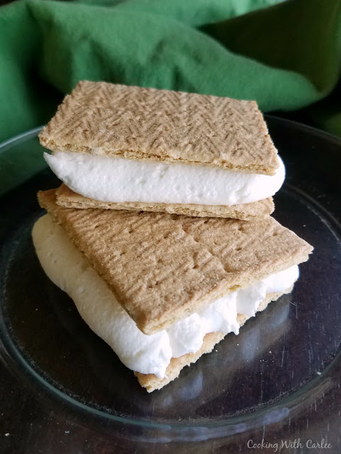toasted marshmallow buttercream is perfect between two graham crackers! stack of two toasted marshmallow frosting and graham cracker sandwiches