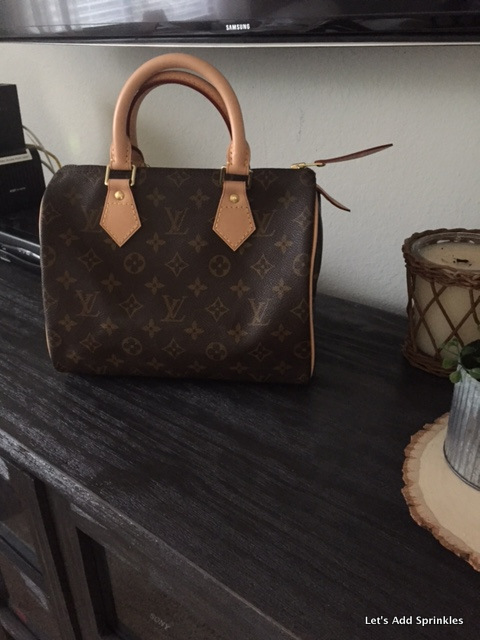 Sold at Auction: A Louis Vuitton Speedy Bag. LV canvas with brown leather  trim and handles. Lock with keys. Red textile interior. The top zip works  but is missing the puller. Please