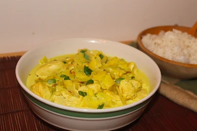 Cabbage and chicken coconut curry with a side of rice.