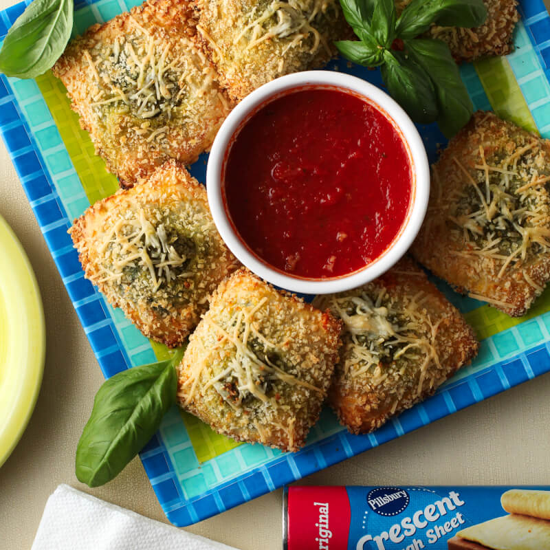 Toasted Spinach Pesto Ravioli, a category winner of the 48th Pillsbury Bake-Off® Contest, is a delicious appetizer recipe perfect for any occasion! #PillsburyBakeOff #MadeAtHome #appetizer #partyfood @Pillsbury #ad